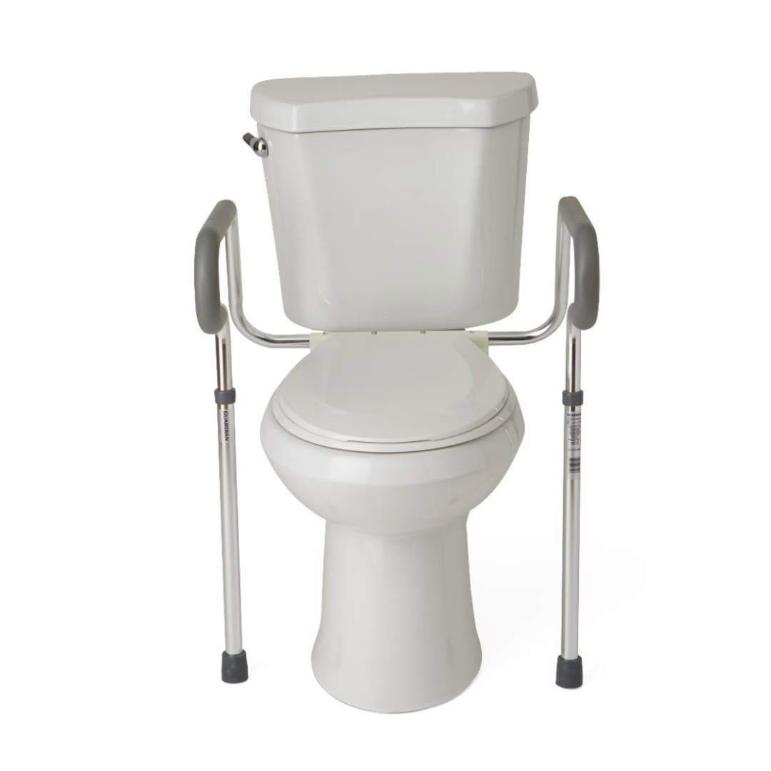 The Medline Aluminum Toilet Safety Rail is a foldable support with an aluminum frame on both sides of a white toilet, designed to assist individuals with mobility challenges by providing extra stability.